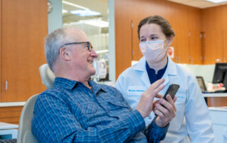 Kaiser Permanente member Alan Crymes with his dentist, Dr. Rebecca Guild, sharing photos of his recent vacation.