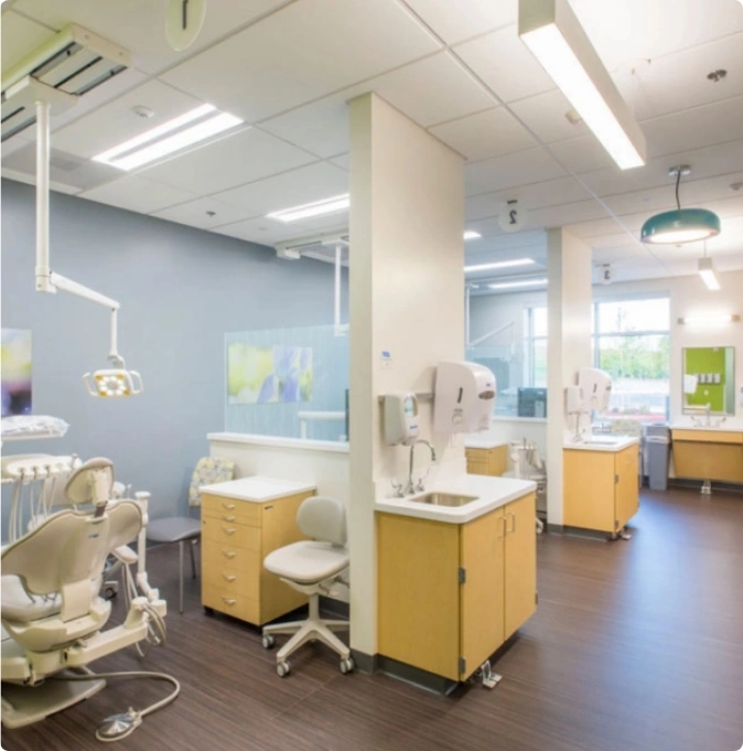 Modern dentist's office with blue walls, white floor, and gleaming dental chair.