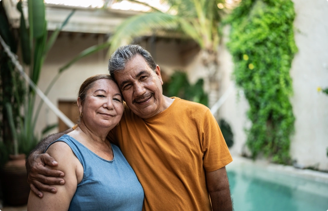 An older couple enjoying a poolside moment together, radiating happiness and relaxation.