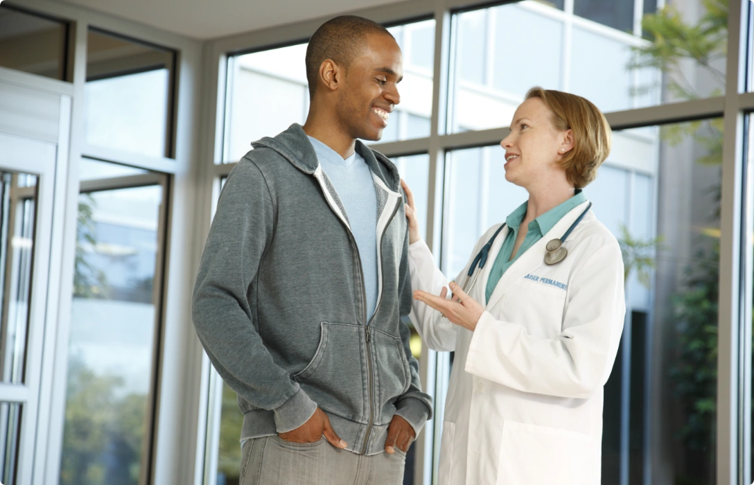 A doctor conversing with a patient in a professional setting.